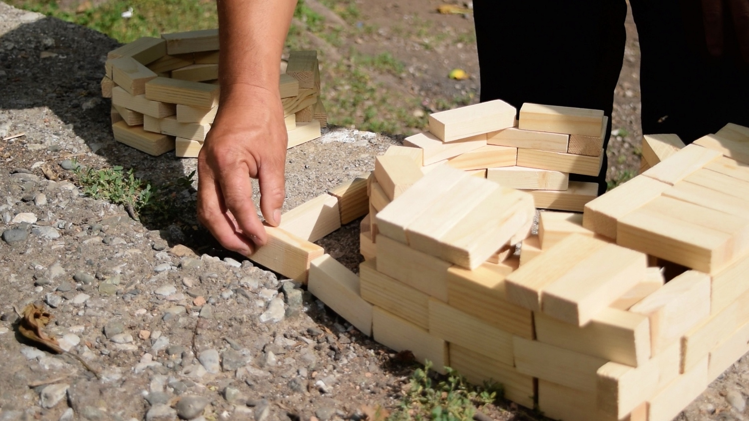 Kyrgyz master craftsman demonstrates the design of a stove using wooden blocks